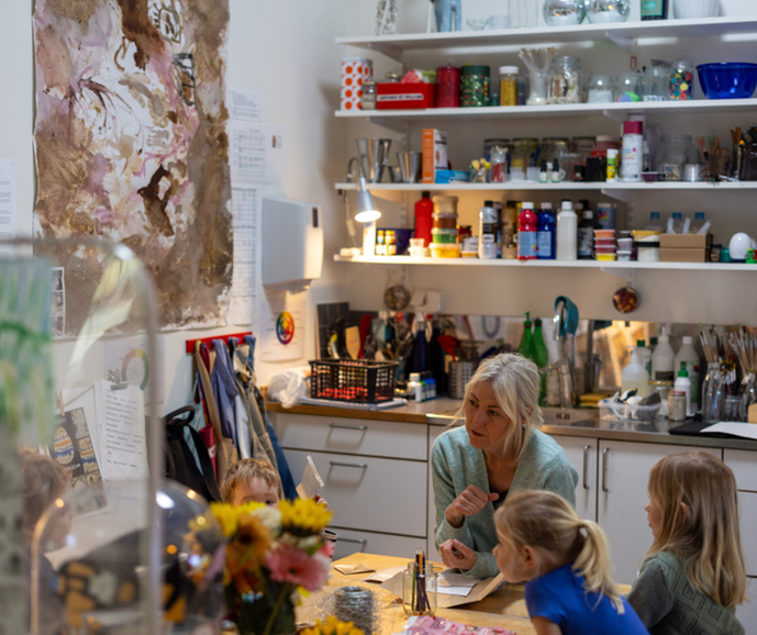 Barnskötare som arbetar med barn vid ett pysselbord